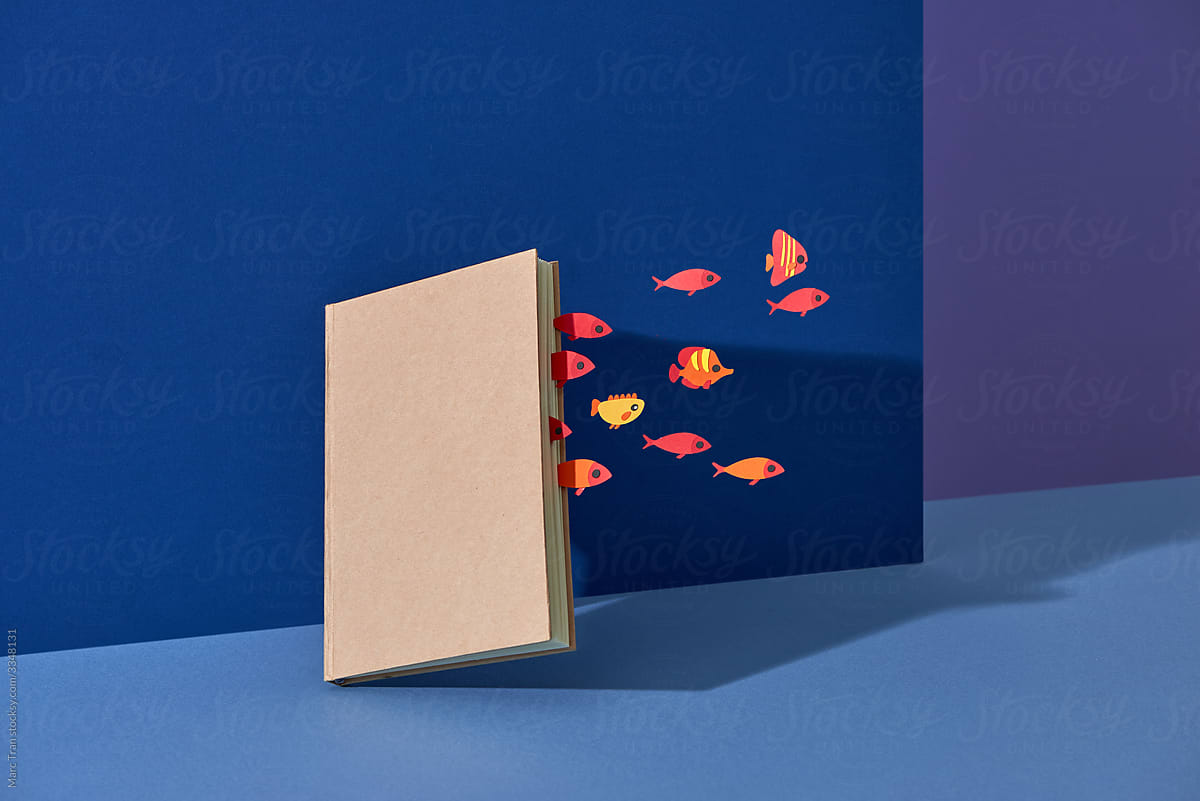 Book about the sea. Paper cut fishes in the ocean