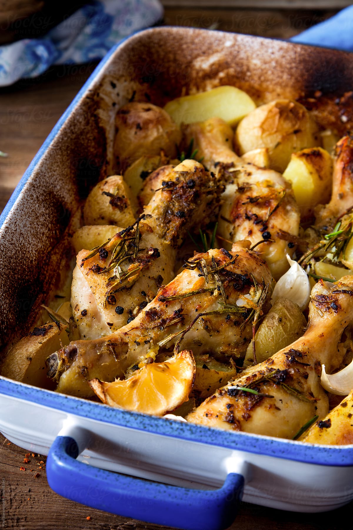 Food: roasted chicken legs on bed of potatoes and herbs
