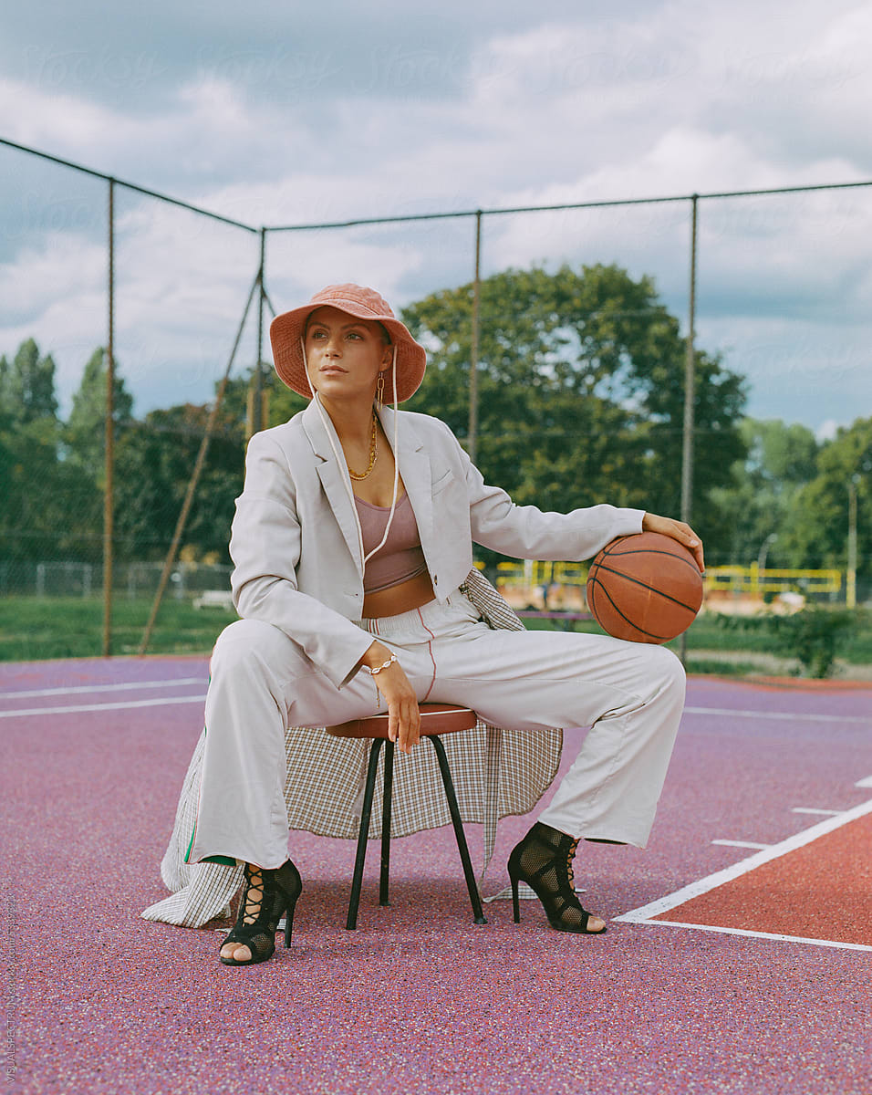 Portrait of Hip Woman Posing In Streetwear On Basketball Court