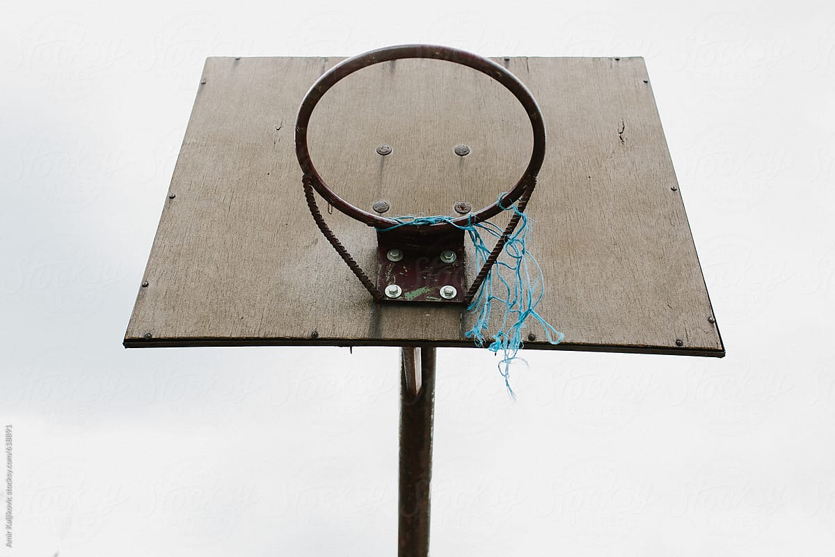 Basketball hoop with broken net mounted on panel