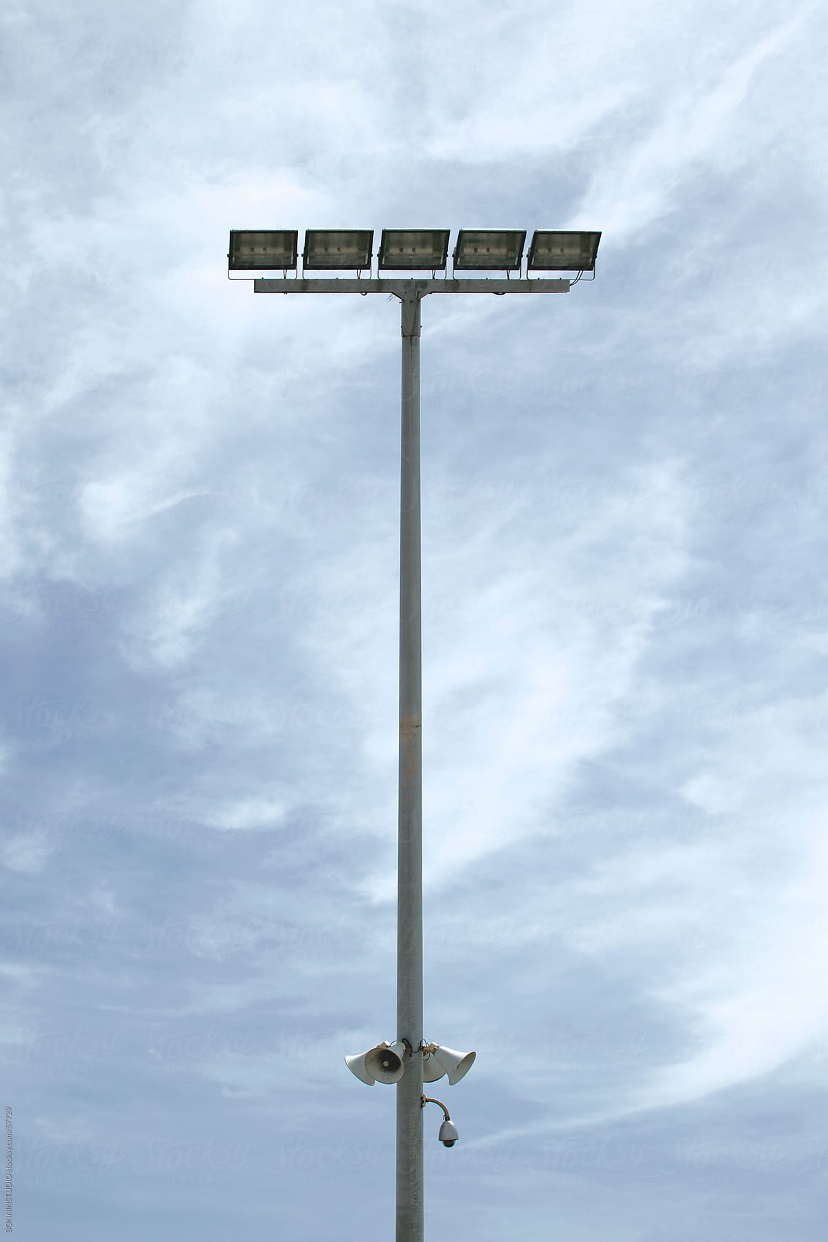 Stadium light over cloudy sky.