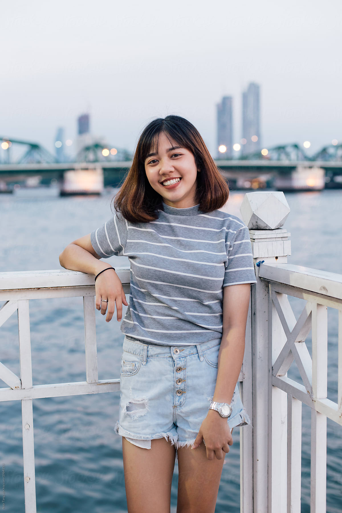 Happy Thai Teenage Girl Portrait By The Riverside In Bangkok By
