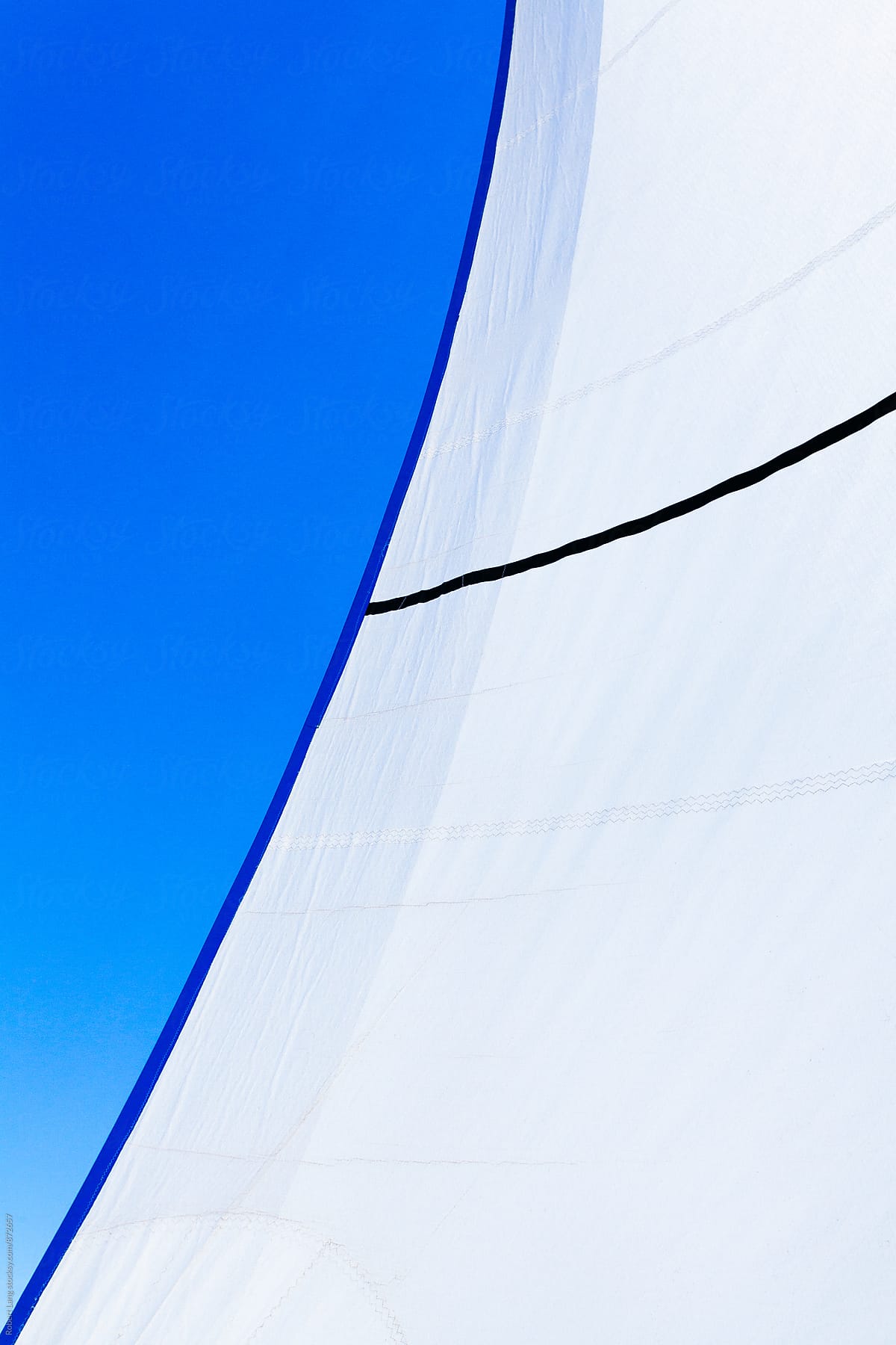 White sails on a blue sky day