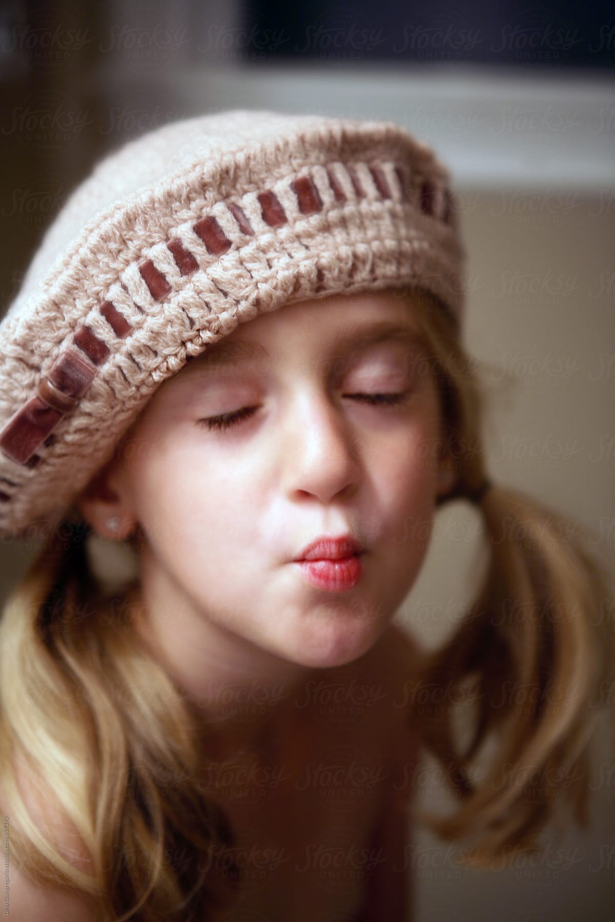 Girl In Knitted Hat Making Kissy Face By Dina Marie Giangregorio