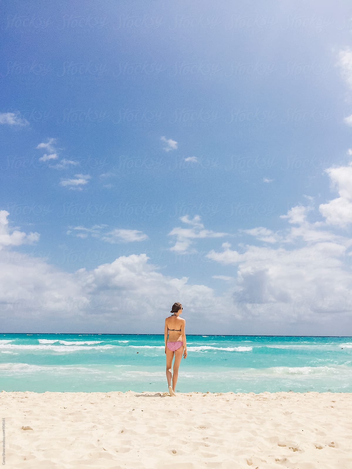 Woman In Bikini Standing On Beach Looking At The Ocean By Stocksy Contributor Carey Shaw