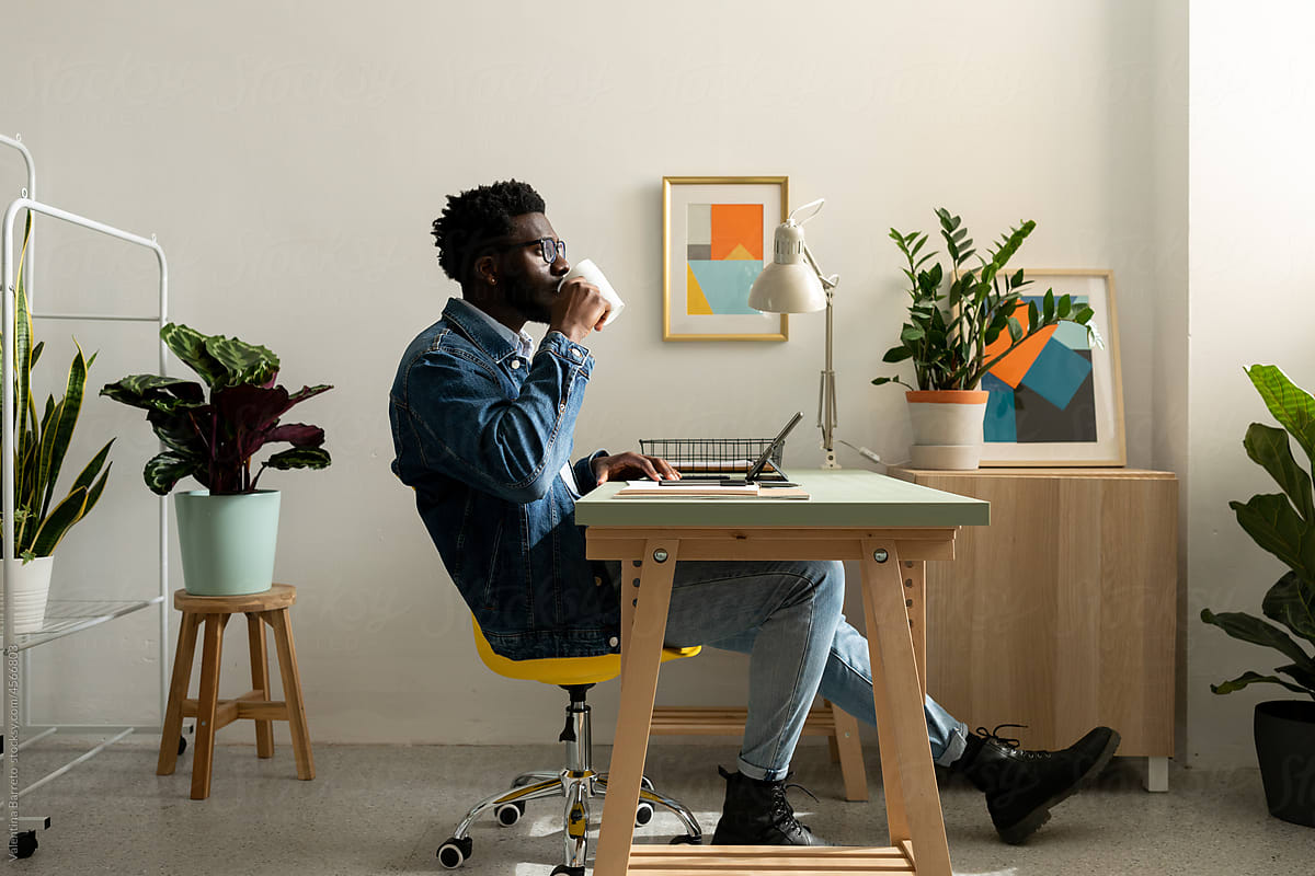 Stylish african designer having coffee at office