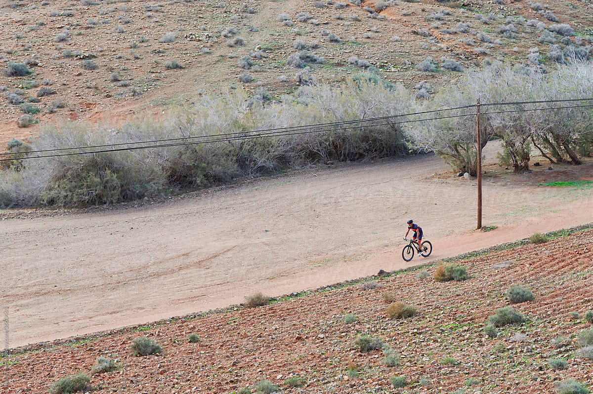 Man out mountain biking on a dirt trail