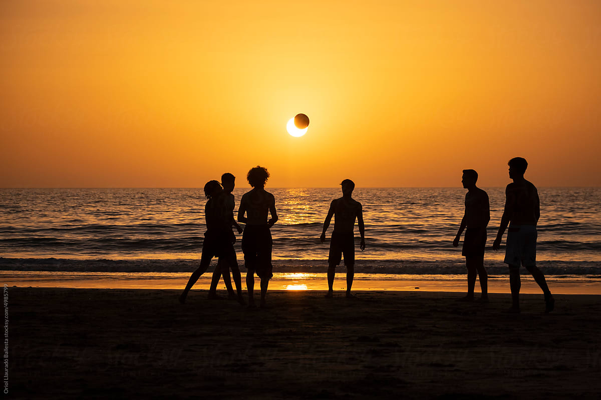 Beach Football Silhouettes At Sunset