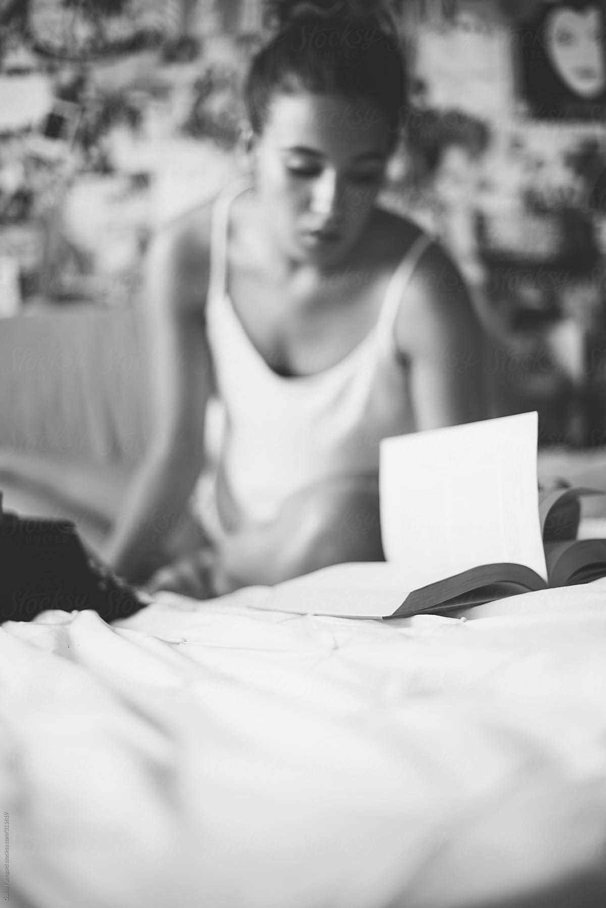 Female student studying on bed