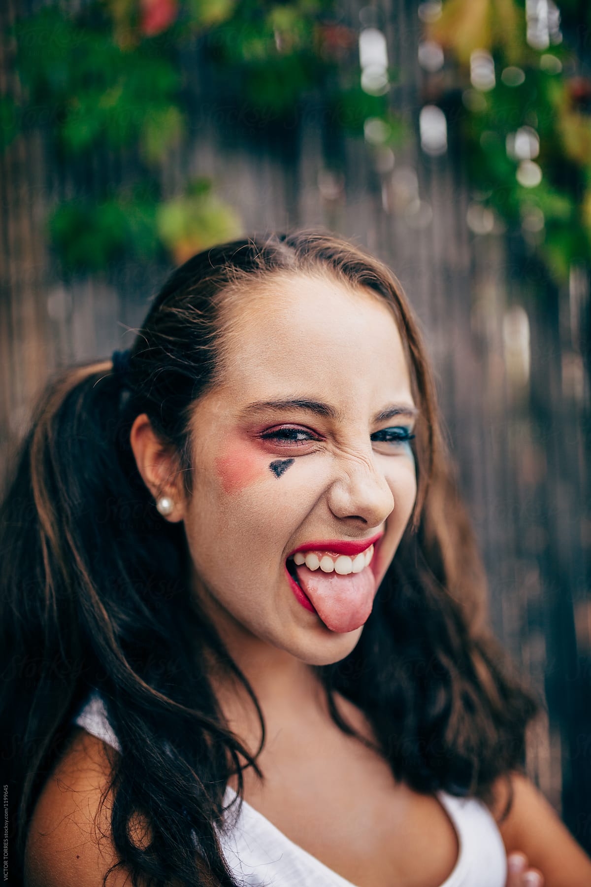Teenager Girl With Punk Makeup Sticking Out Tongue By Stocksy Contributor Victor Torres 