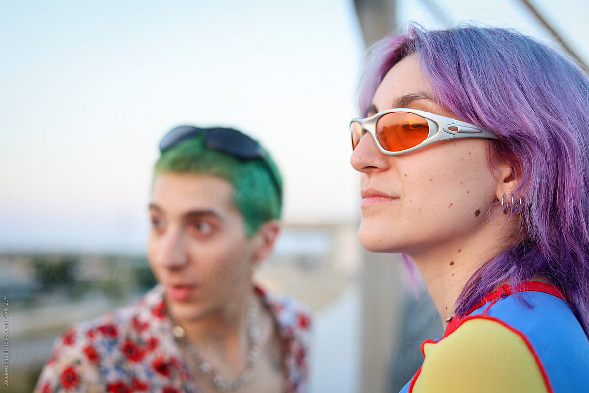 Fashionable Gen Z young couple with colorful hair and sunglasses
