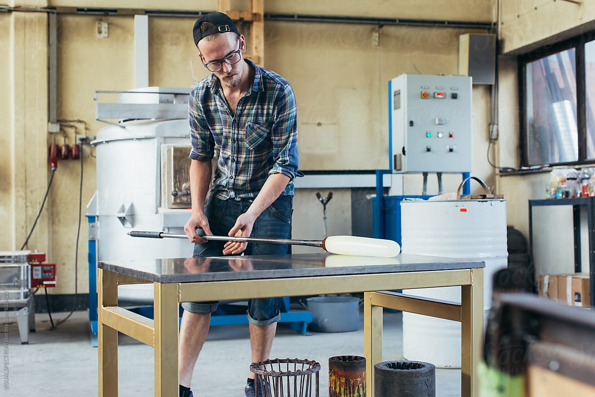 Artisan Glass Workshop - Young Male Hipster Artisan Glass Artist Rolling Hot Glass
