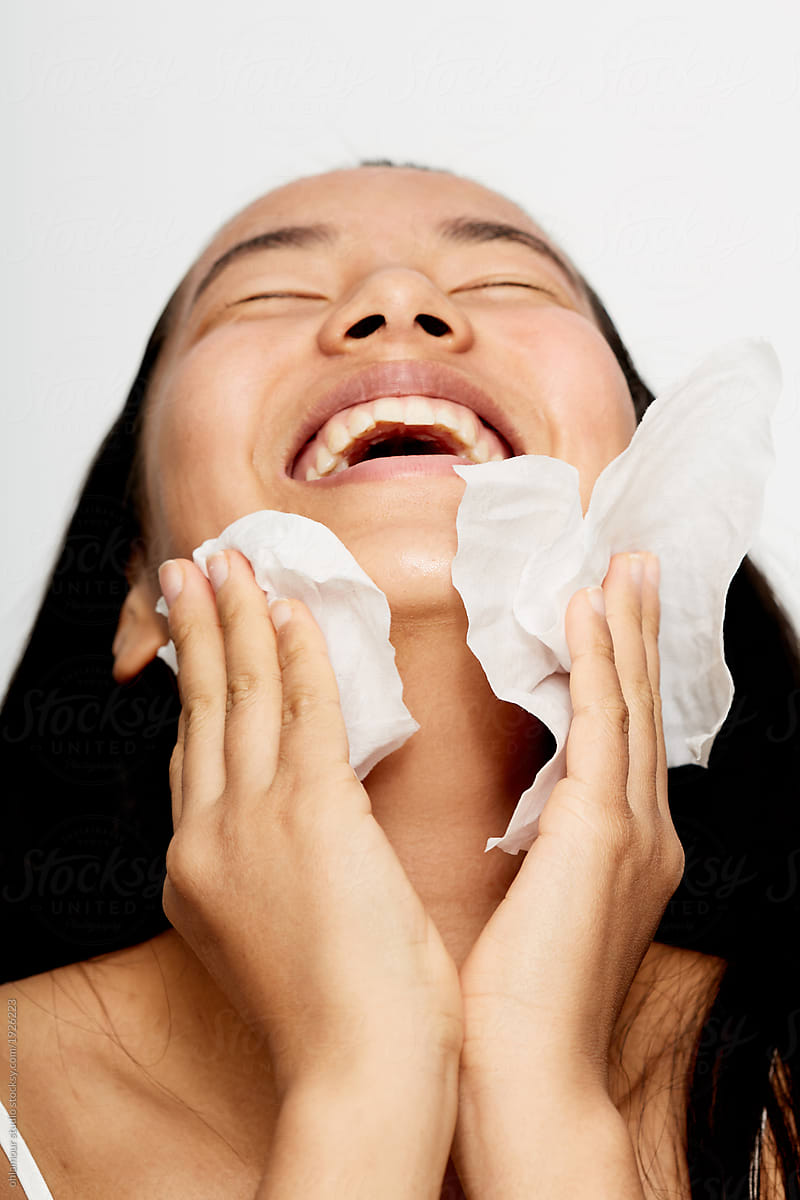 Beautiful young asian woman cleaning her face.