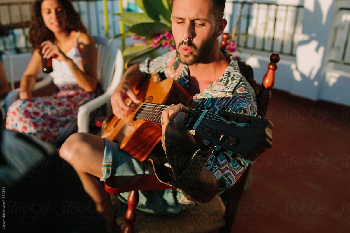 Man singing and playing a spanish guitar