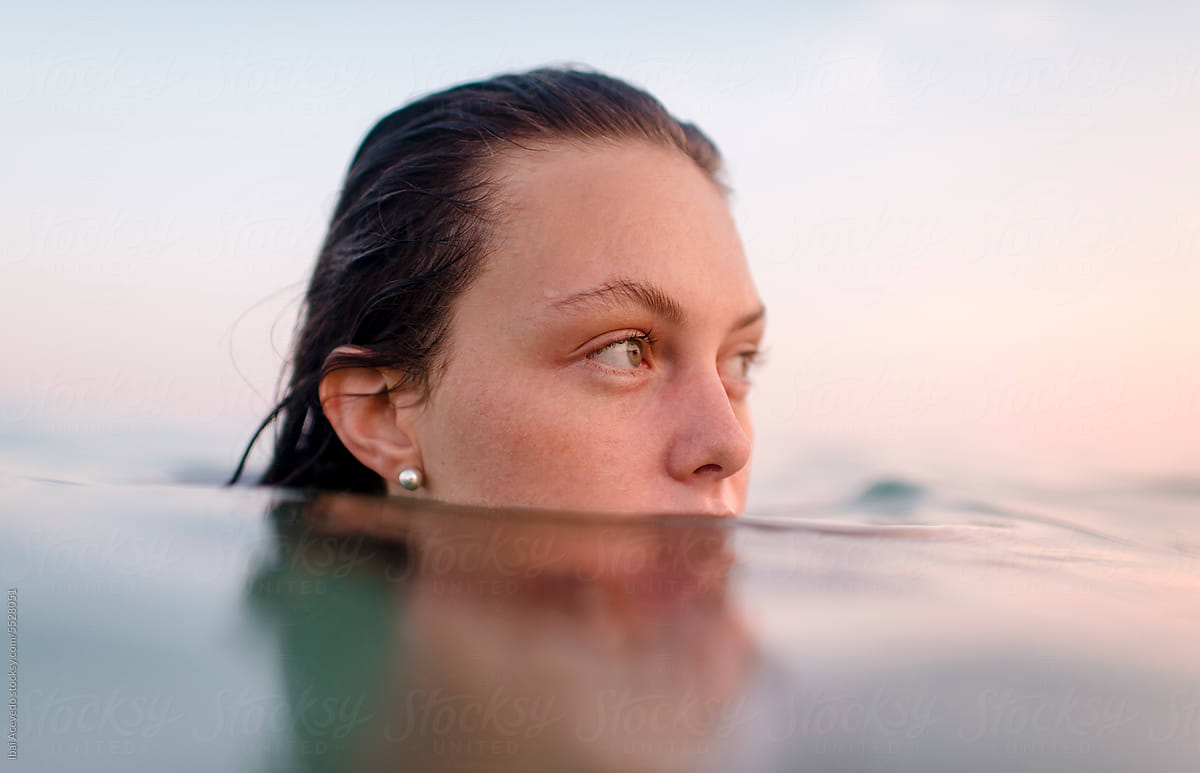 Relaxed woman enjoying sunset swimming