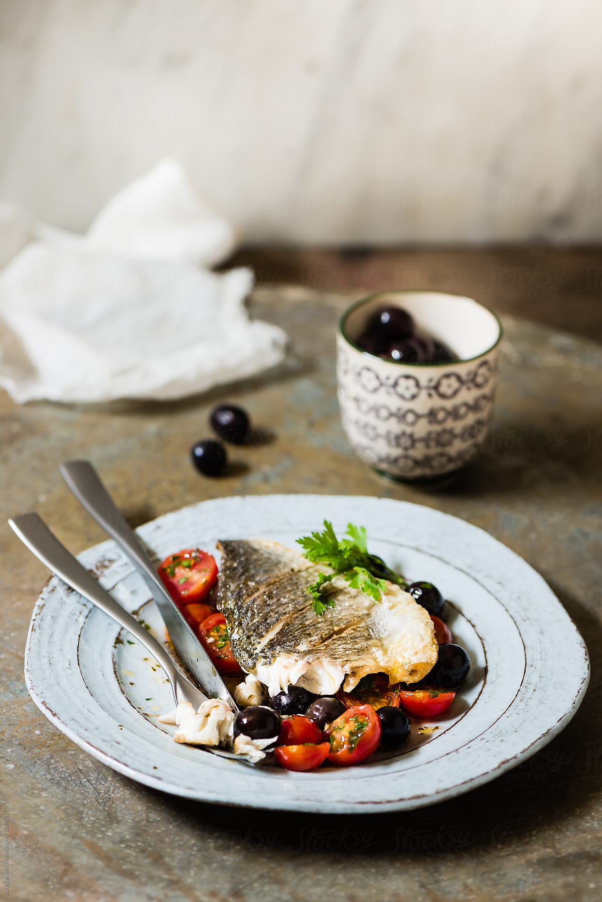 Seabream fillet with cherry tomatoes and black olives
