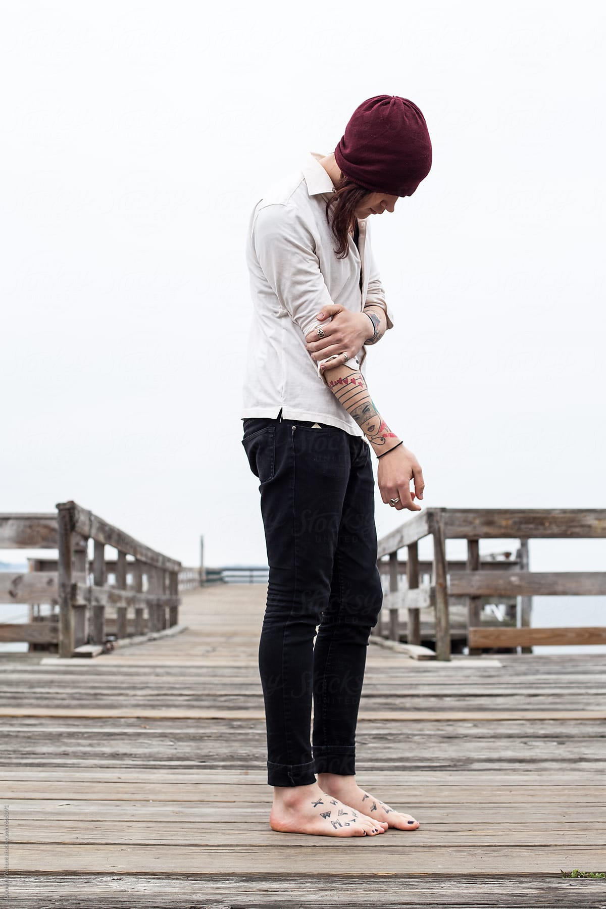 Portrait of a gender neutral, gender fluid person person standing on pier