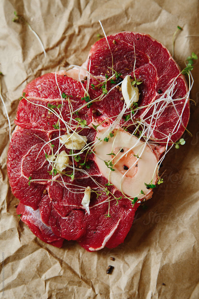 Raw steak with herbs and garlic