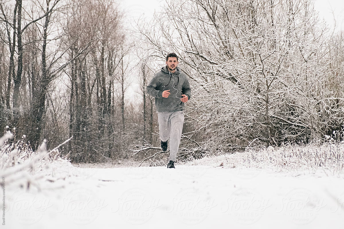 Man running against of winter landscape