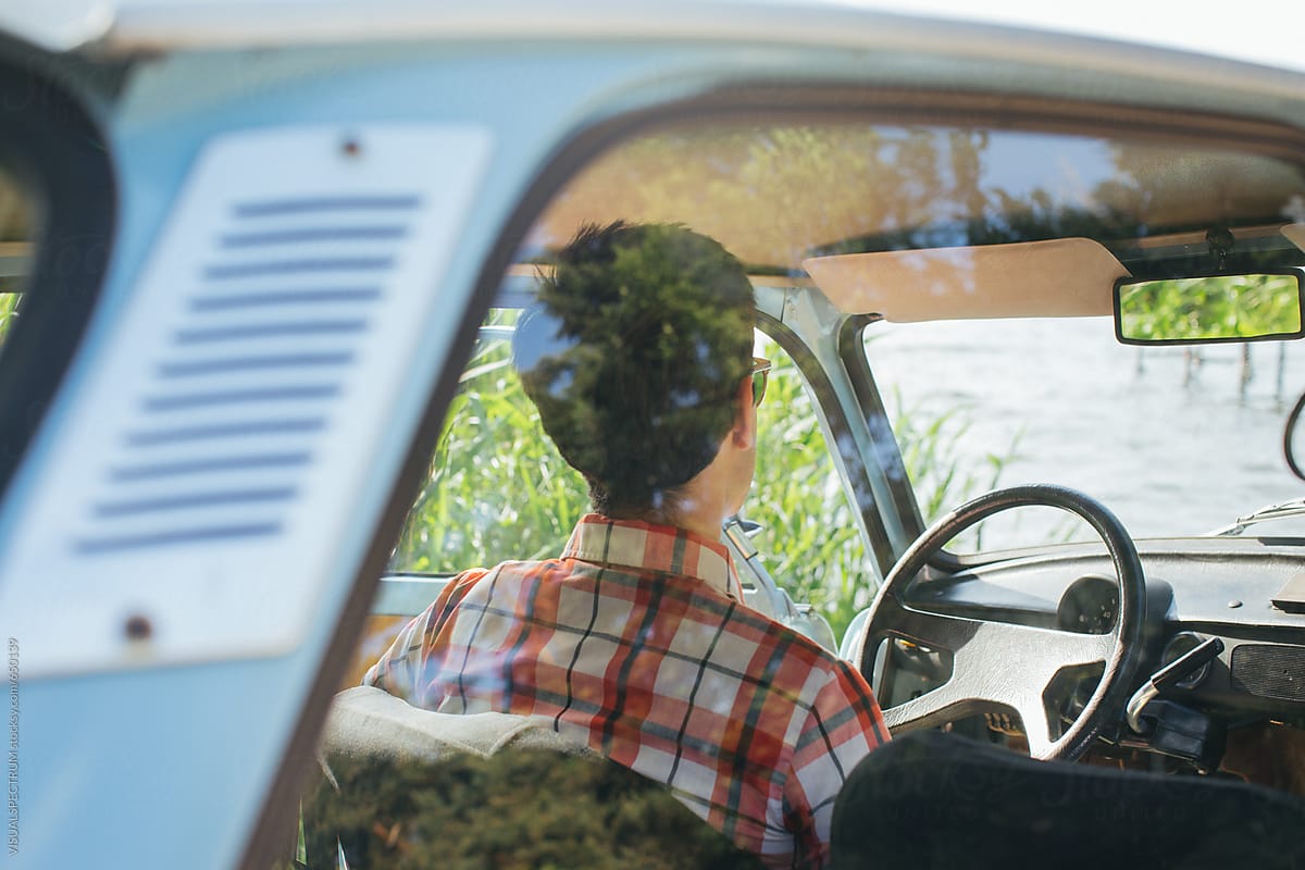 Young Man Chilling in Vintage Car From Behind
