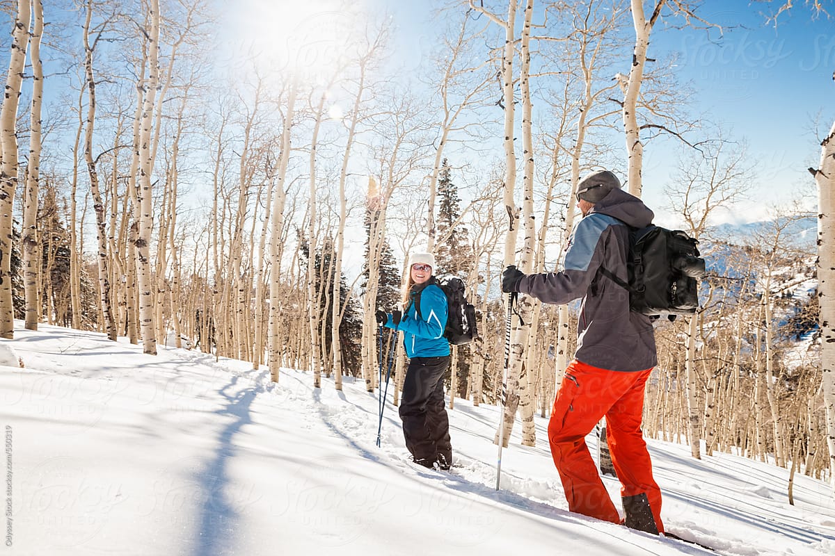 Couple Stops to Chat While Snowshoeing