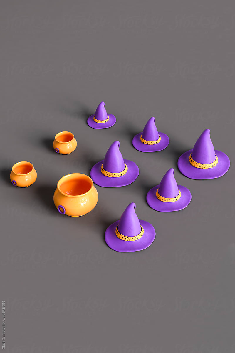 orange cauldrons and purple witch hats on dark grey background