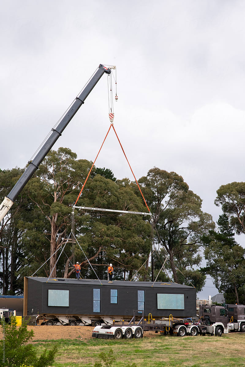 Modular home being delivered to lifestyle block and craned into position