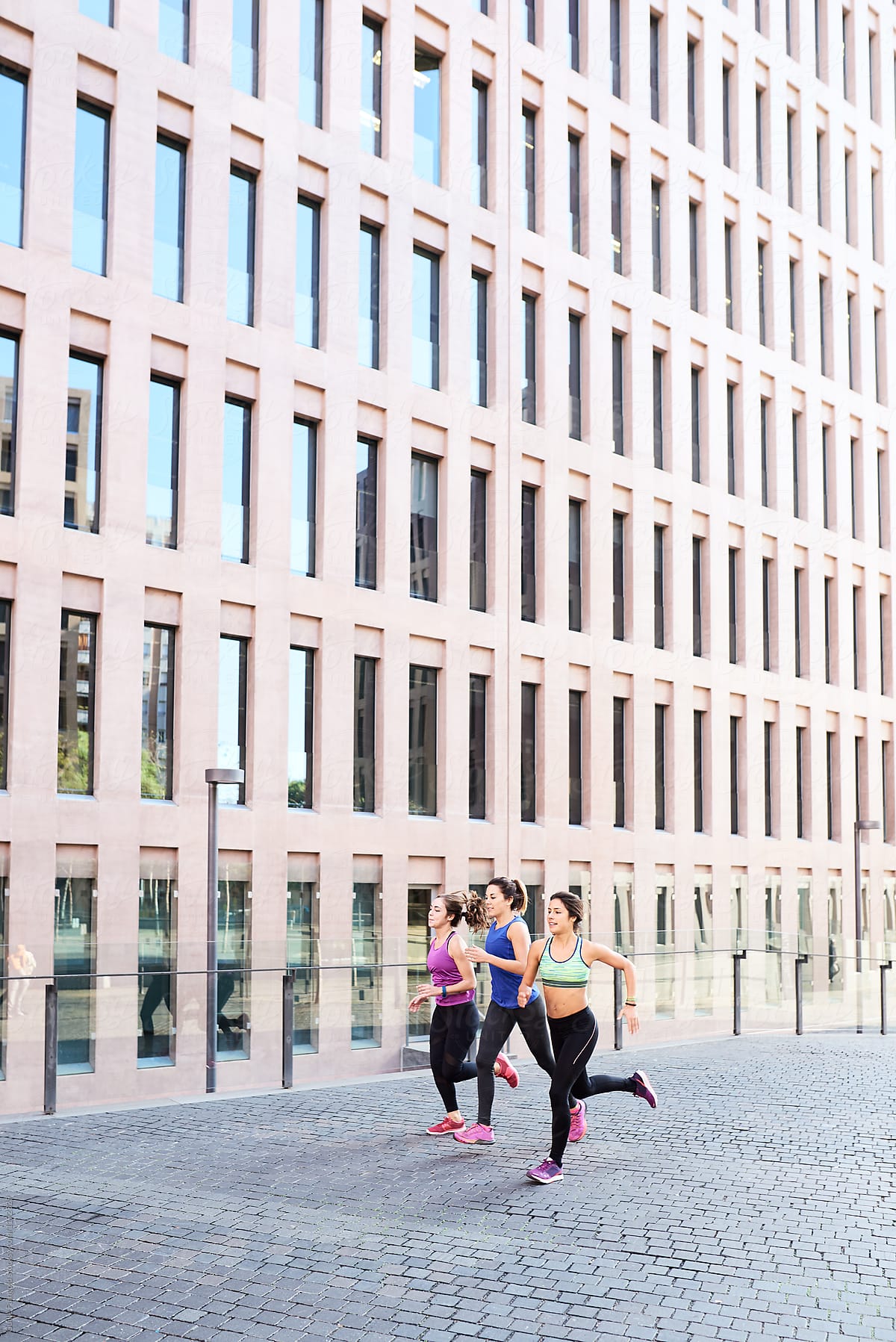 Sportswomen Running Outside Modern Building By Stocksy Contributor Guille Faingold Stocksy