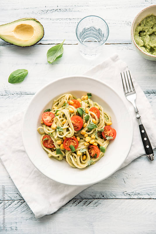 Food: Spaghetti with vegan avocado pesto with garlic, basil, cherry tomato, lemon and corn