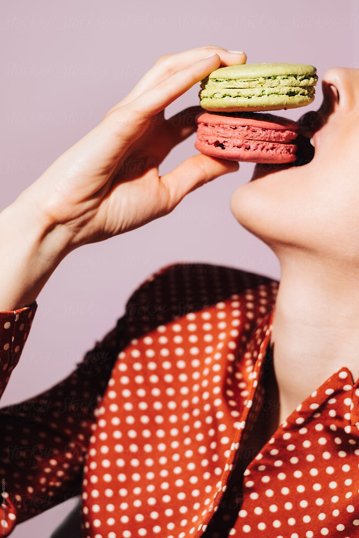 Sensual Woman Posing While Eating Two Macarons
