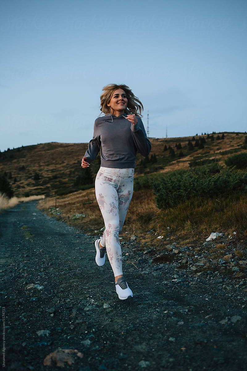 Girl running on the mountain trail