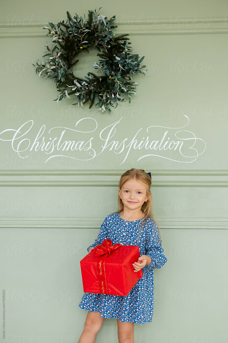 Little girl holding a box of gifts.