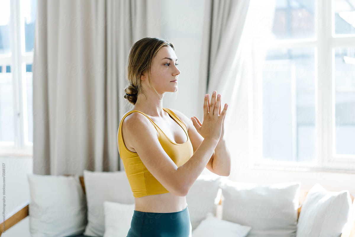 Woman clasping hands during meditation