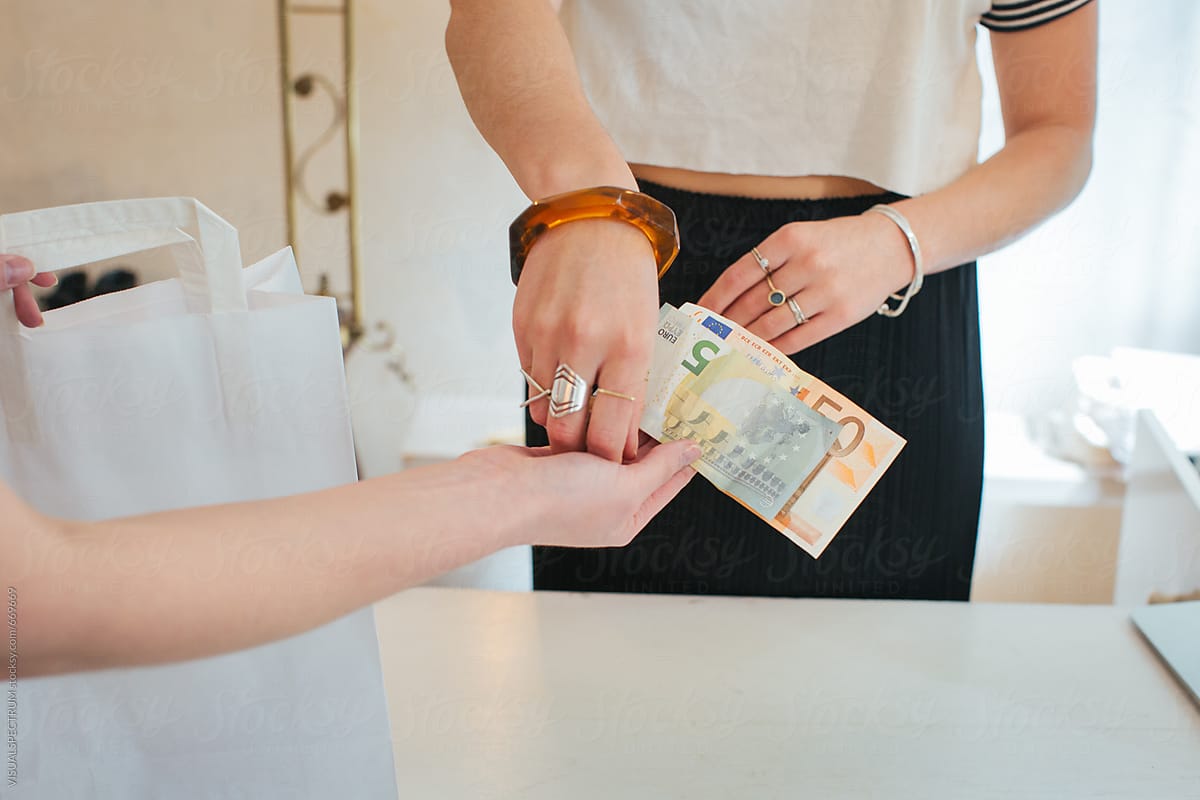 Shopping - Close Up of Caucasian Cashier Receiving Euro Bills From Female Customer