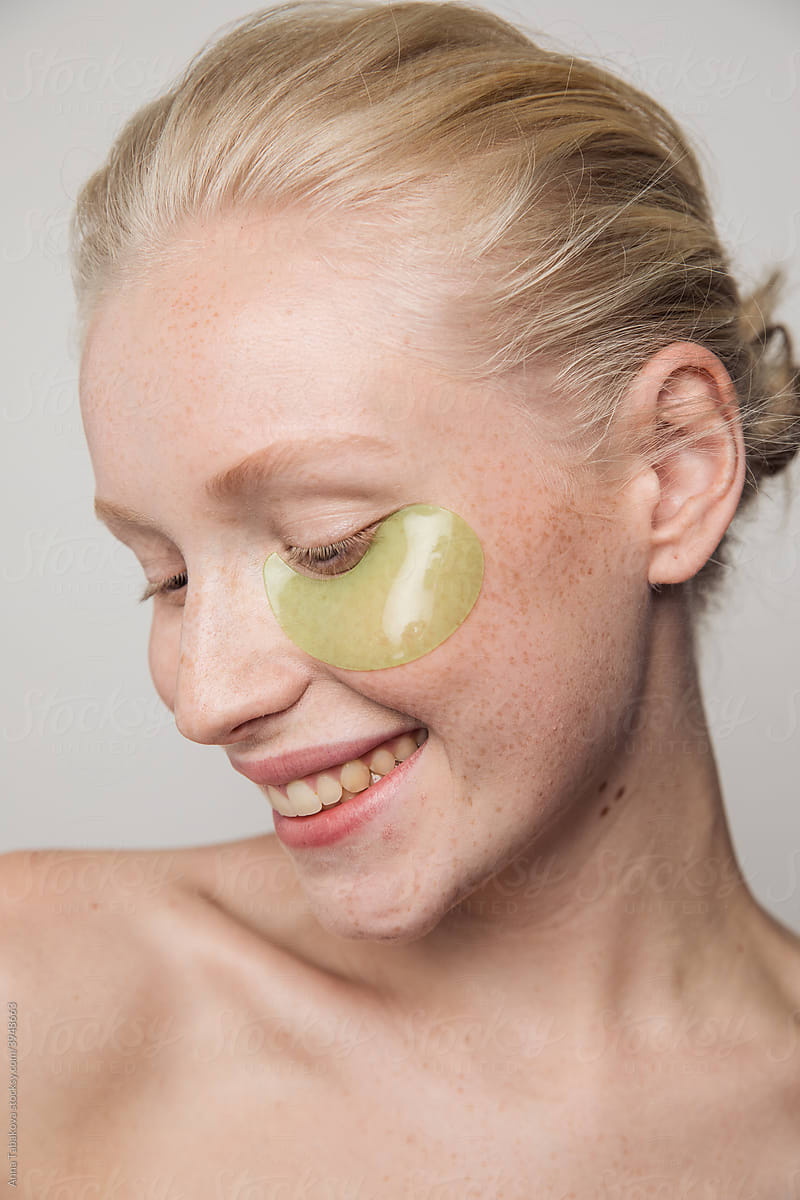 Young happy freckled model with green under eyepatches
