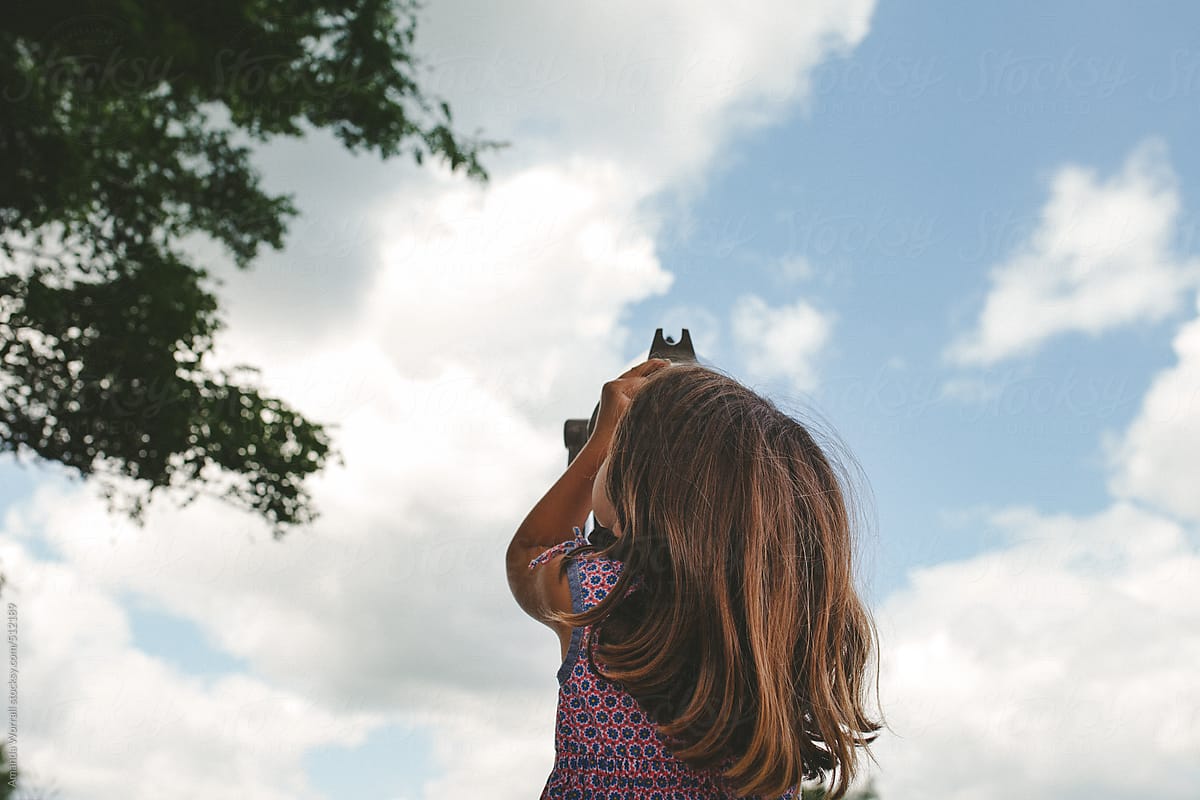 little girl looking up at the sky