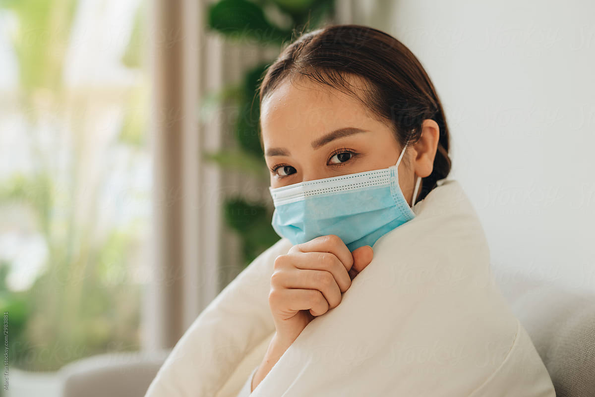 Sick woman wearing mask with flu