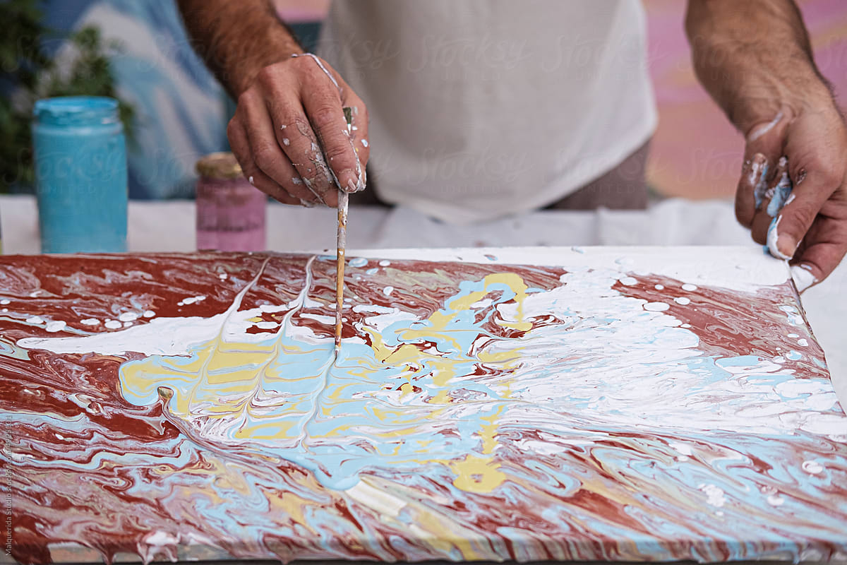 Anonymous artist painting a pour picture