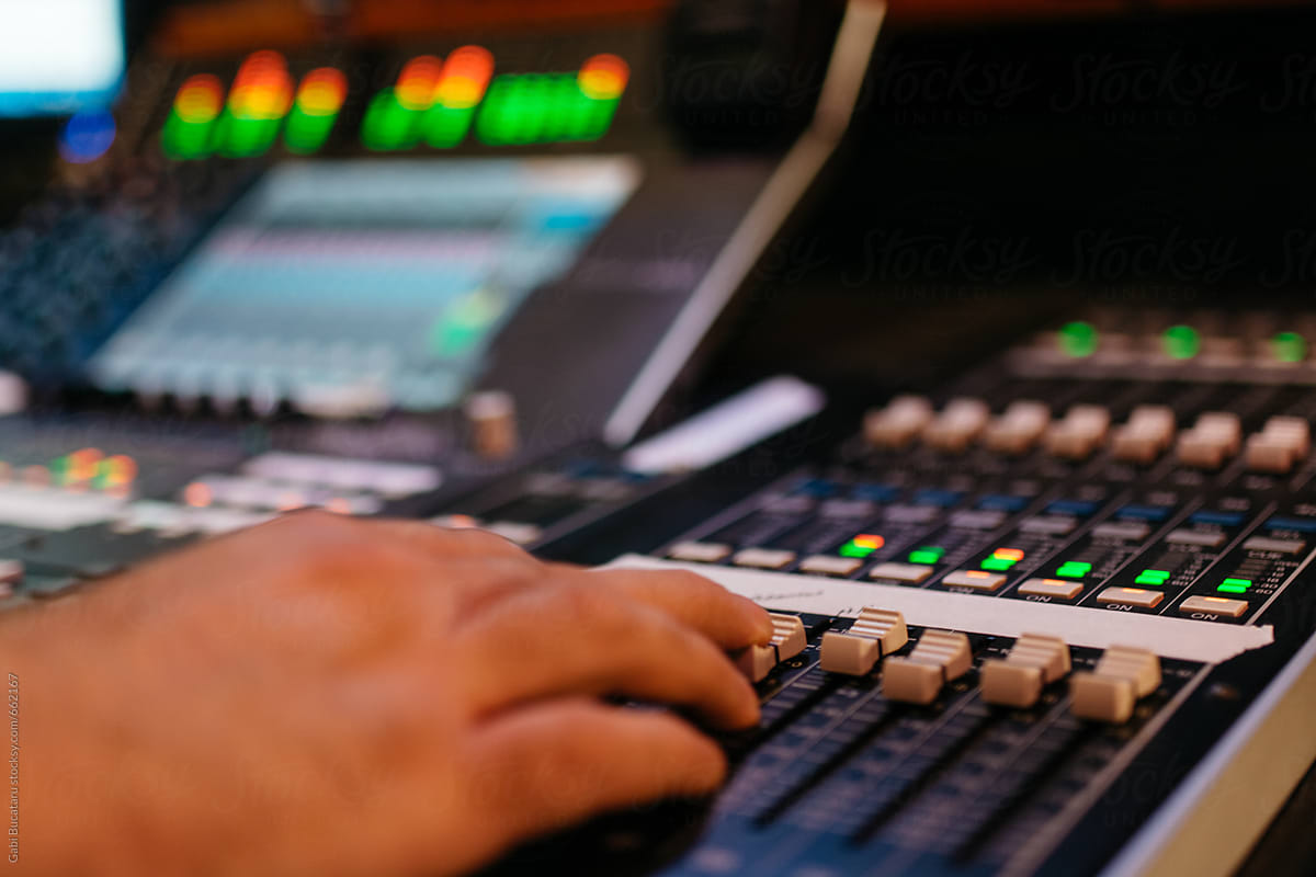 Sound engineer\'s hand on mixer board