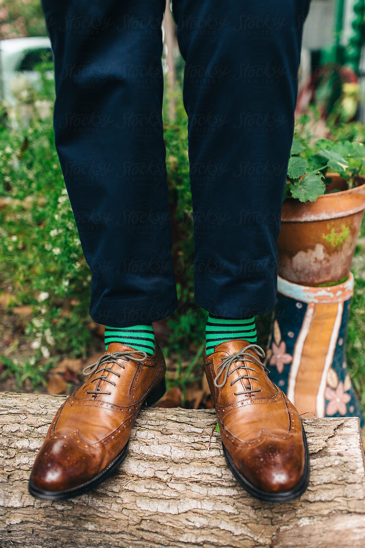 A mans brown oxford shoes & green socks