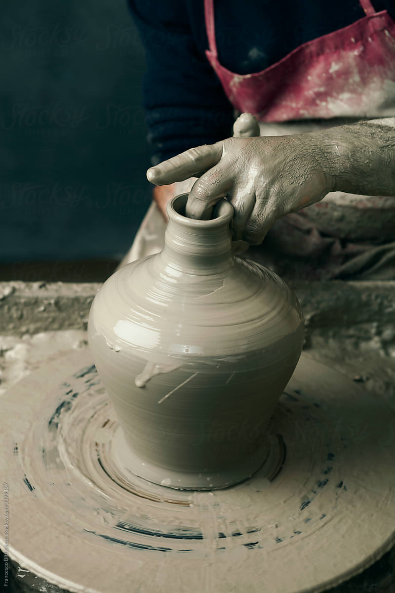 Ceramist, man\'s hands working on clay