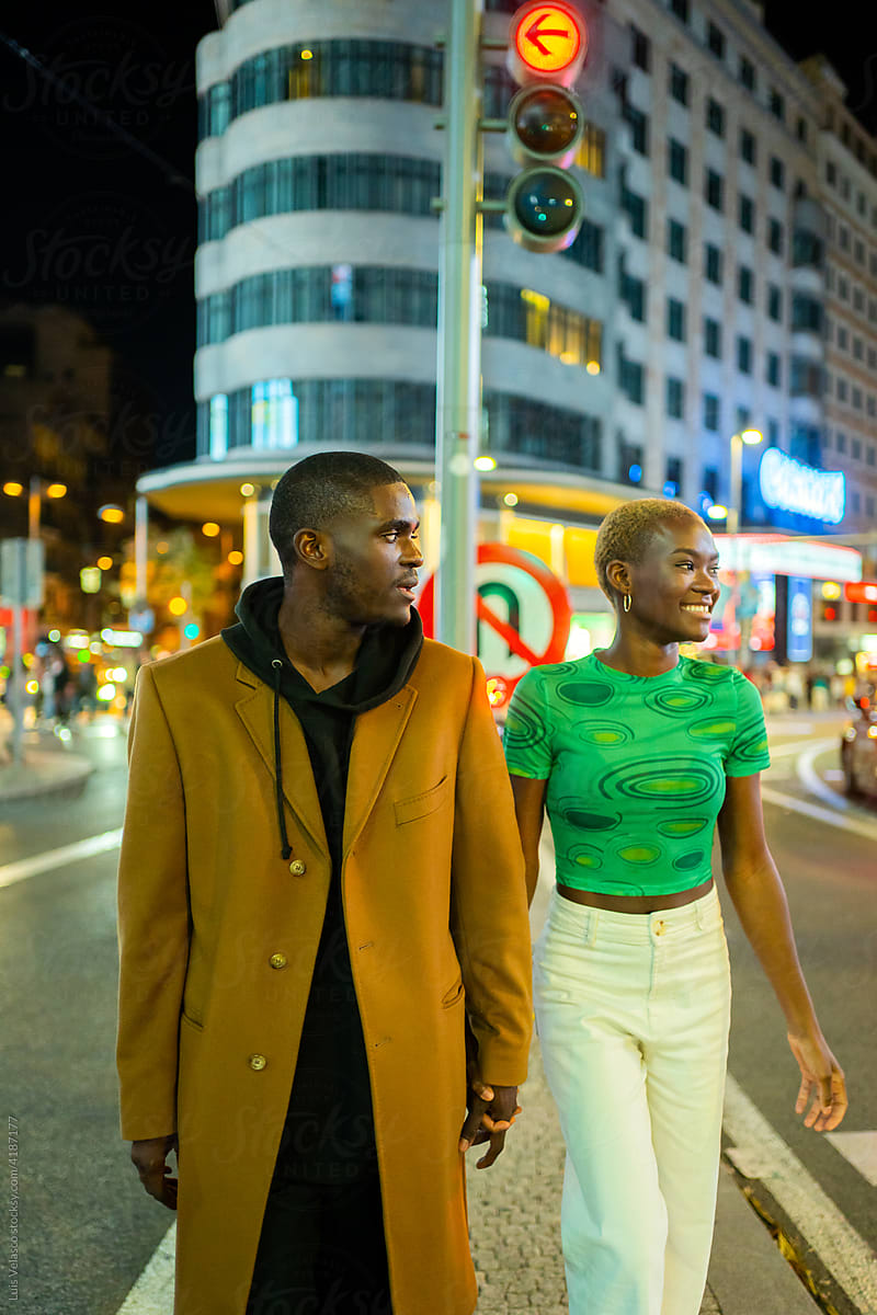 Black Couple In Love Walking On The Street At Night.