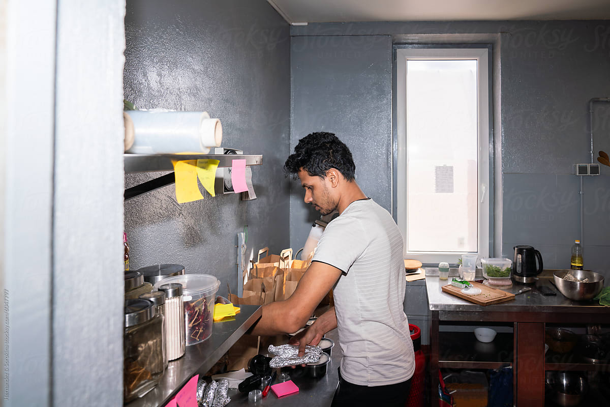 Indian Restaurant Worker Preparing Take Away Orders