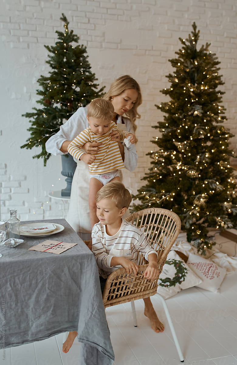 mother with children at the kitchen table at home Christmas holiday new year mood