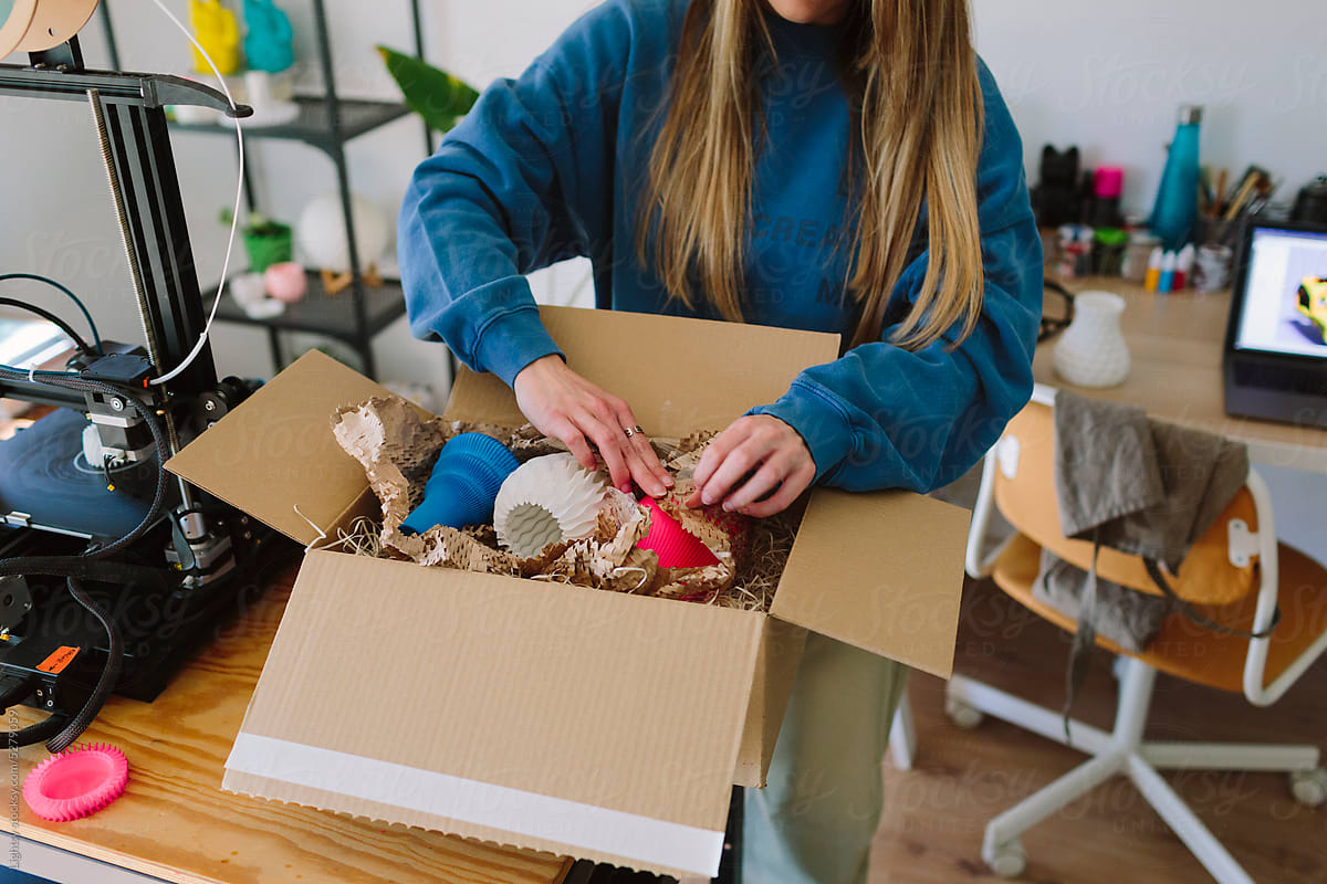 A woman packs up items for online selling