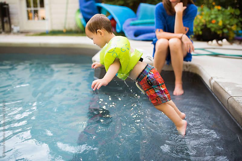 A young boy swimming in a pool