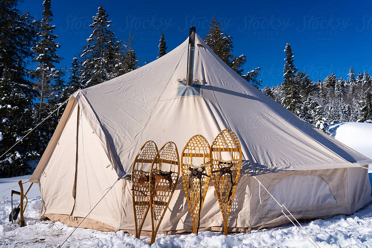 Canvas Tent on Wilderness Frozen Lake with Snowshoes