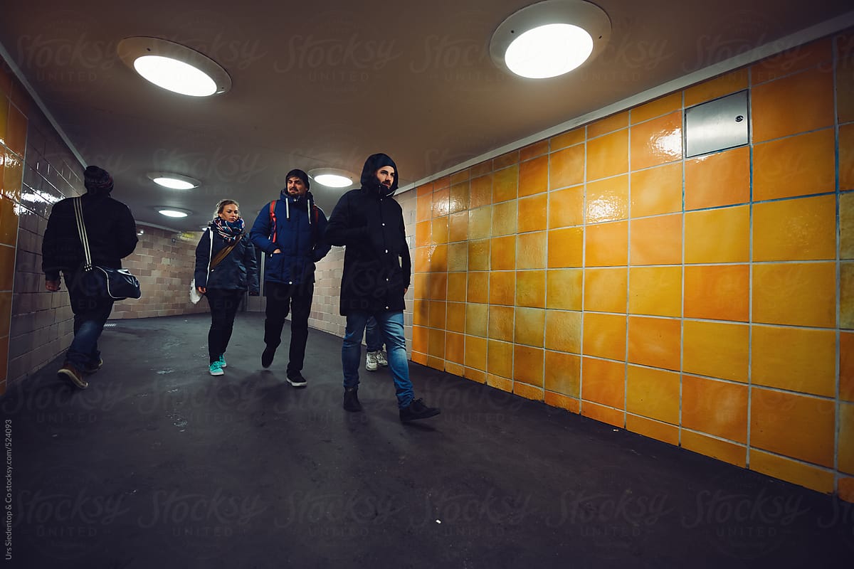 Group of people walking trough pedestrian subway
