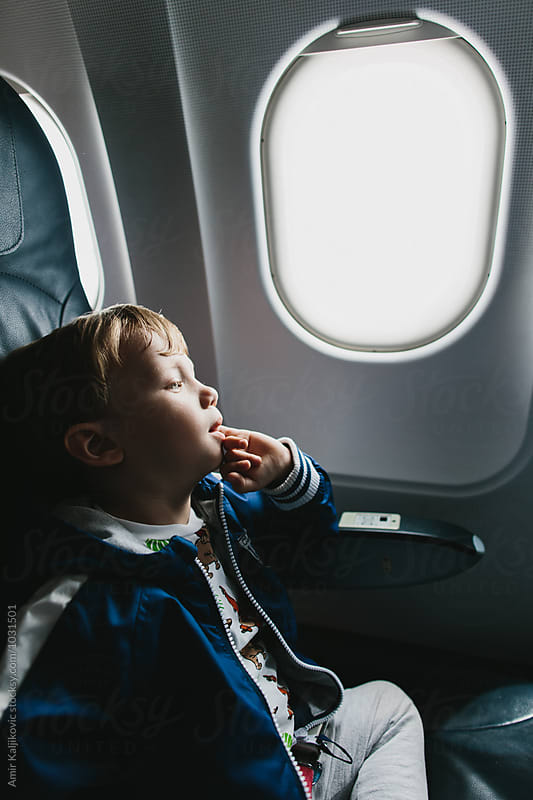 Small boy resting in an aircraft seat