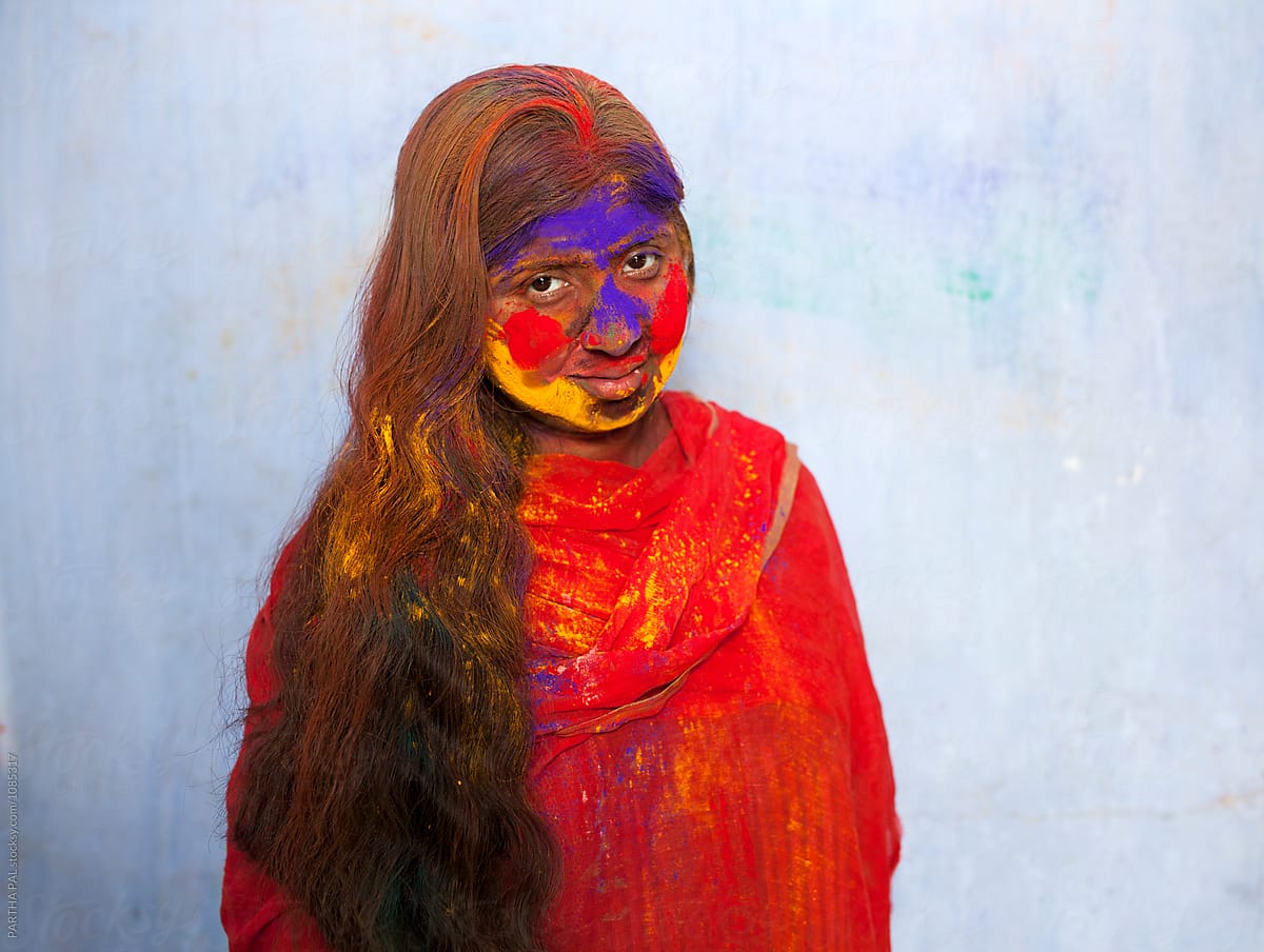 Indian woman with colorful face in Holi festival